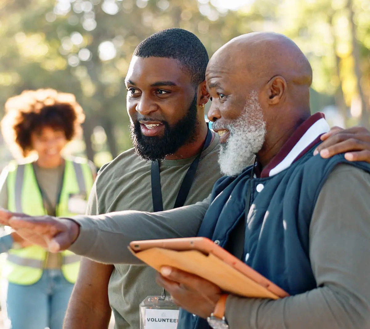Two men talking and smiling outdoors.