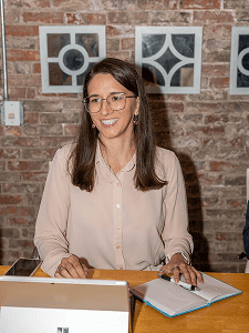 Smiling woman working at a desk.